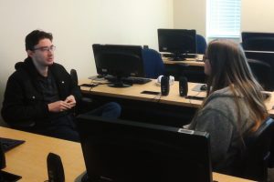 OLS Students face each other to practice mock interviews in class