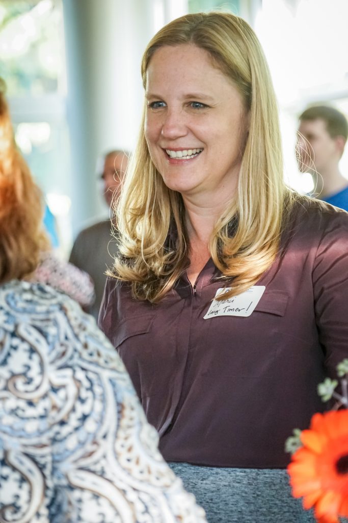 Marci Muhlestein smiling and taling with students