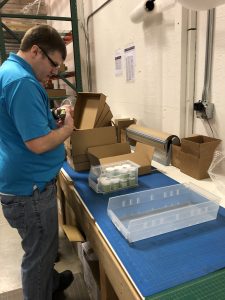 OLS Student helping fulfill orders at his internship