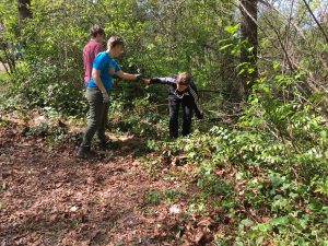 Students working at Idylwood Park pulling weeds