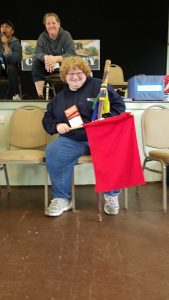 JoAnn smiling and holding the spirit stick