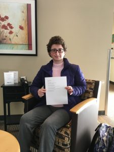 Cassidy holds up her poem 