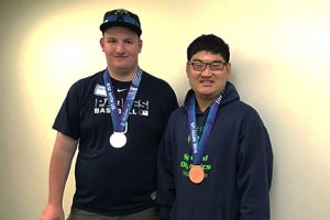 Will and Garrett smile for the camera wearing their bronze Olympic medals