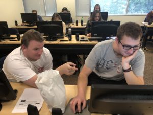 Students work together at a computer