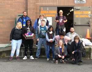 Students pose in a group photo outside Jubilee REACH Thrift Store