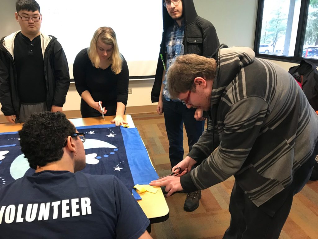students work together to complete blanket
