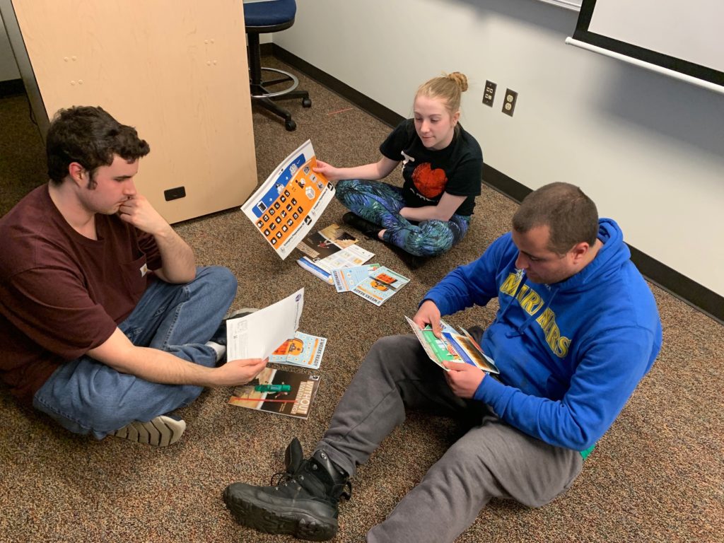 three students work on a project together