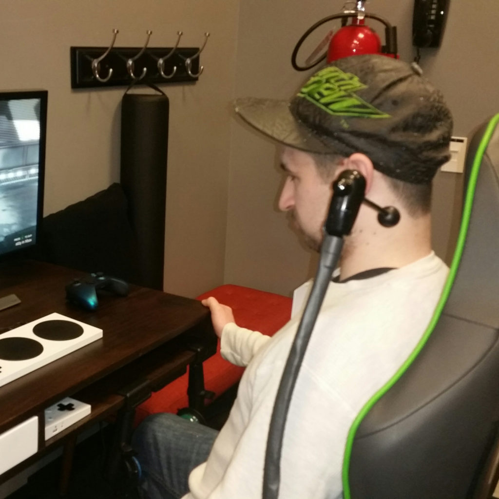 Student plays video game with adaptive controller