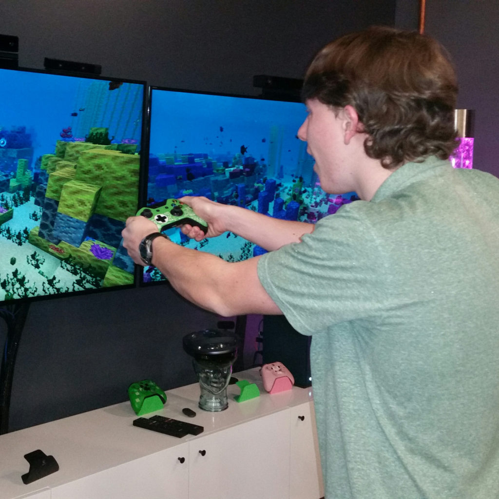 Student plays video games with adaptive controller