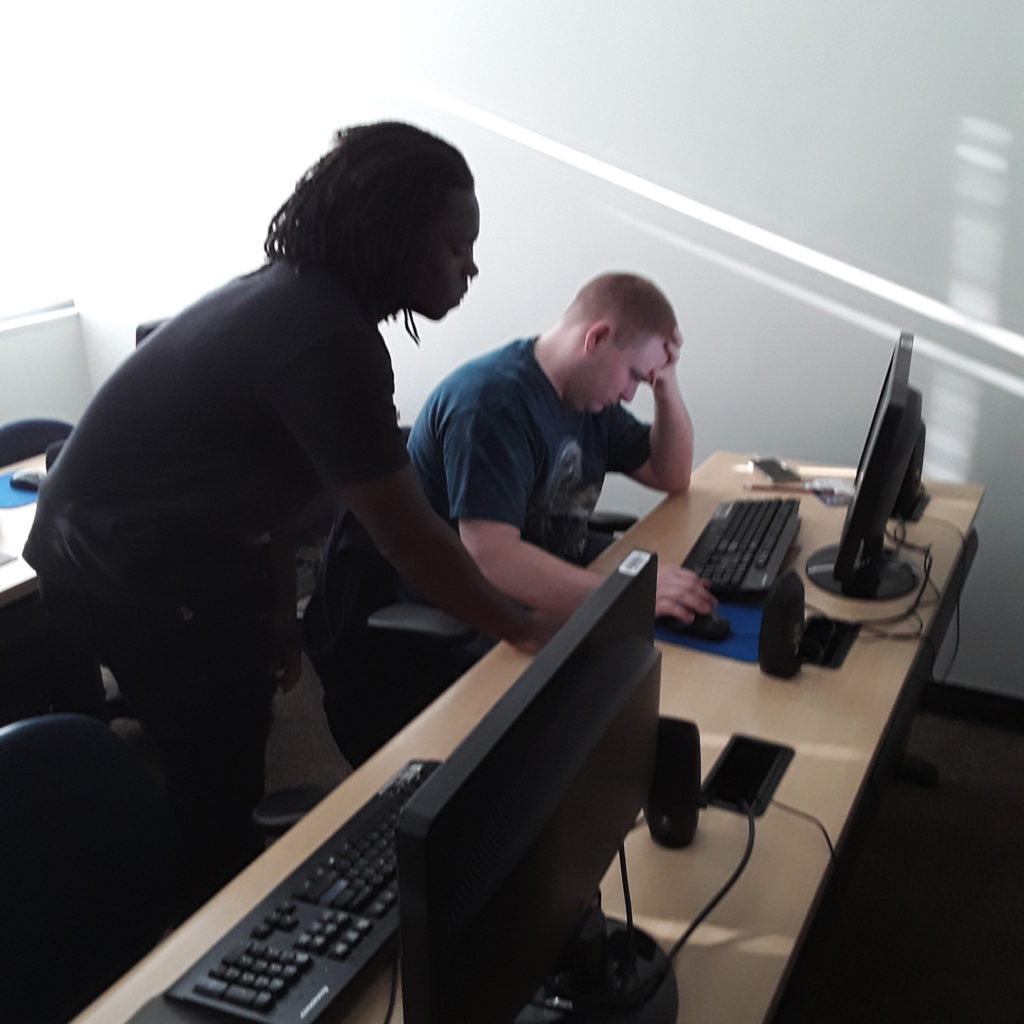 two students working at a computer together
