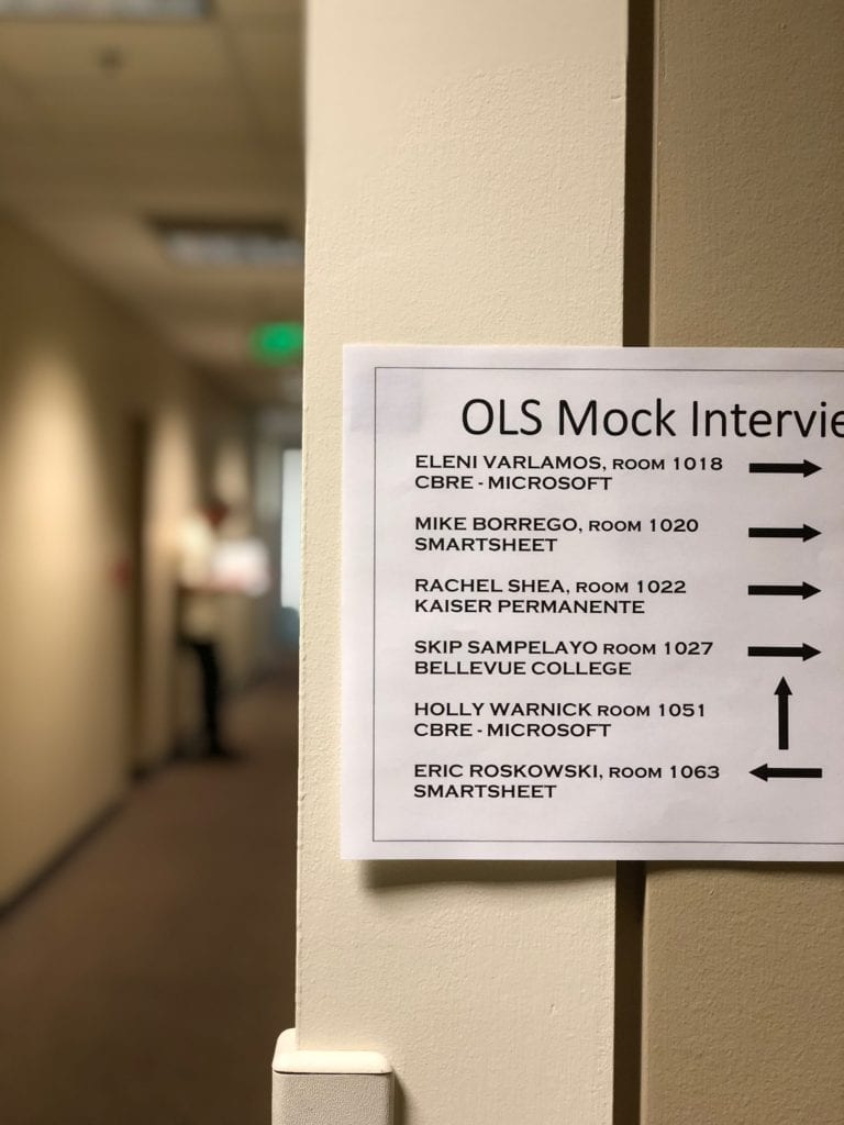 Sign on wall indicating where mock interviewers are taking place