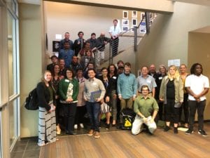 Large group of young adult students and professionals group photo on staircase