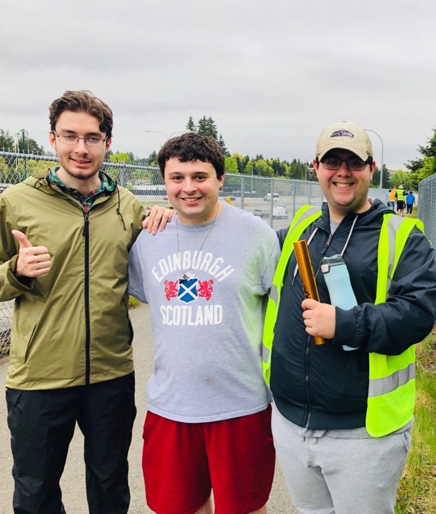 small group of young adults outside smiling for a group photo