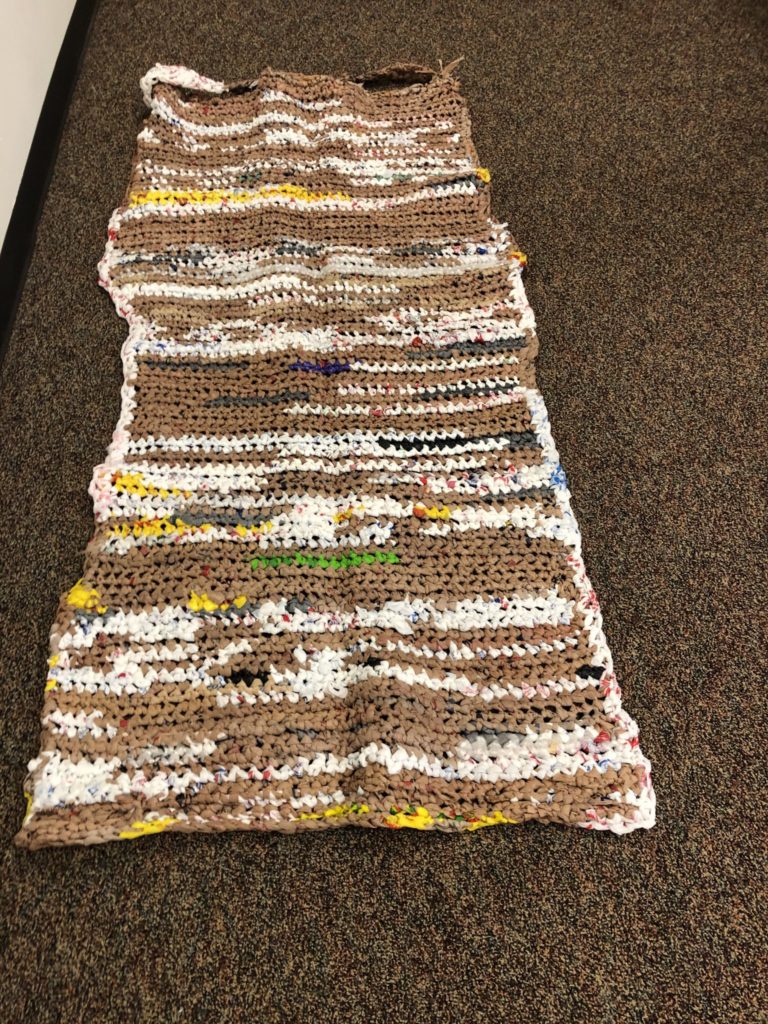 students work on making plarn out of plastic bags