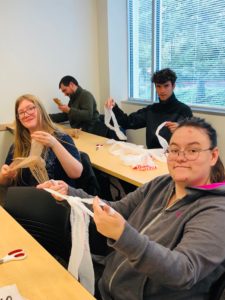 students work on making plarn out of plastic bags