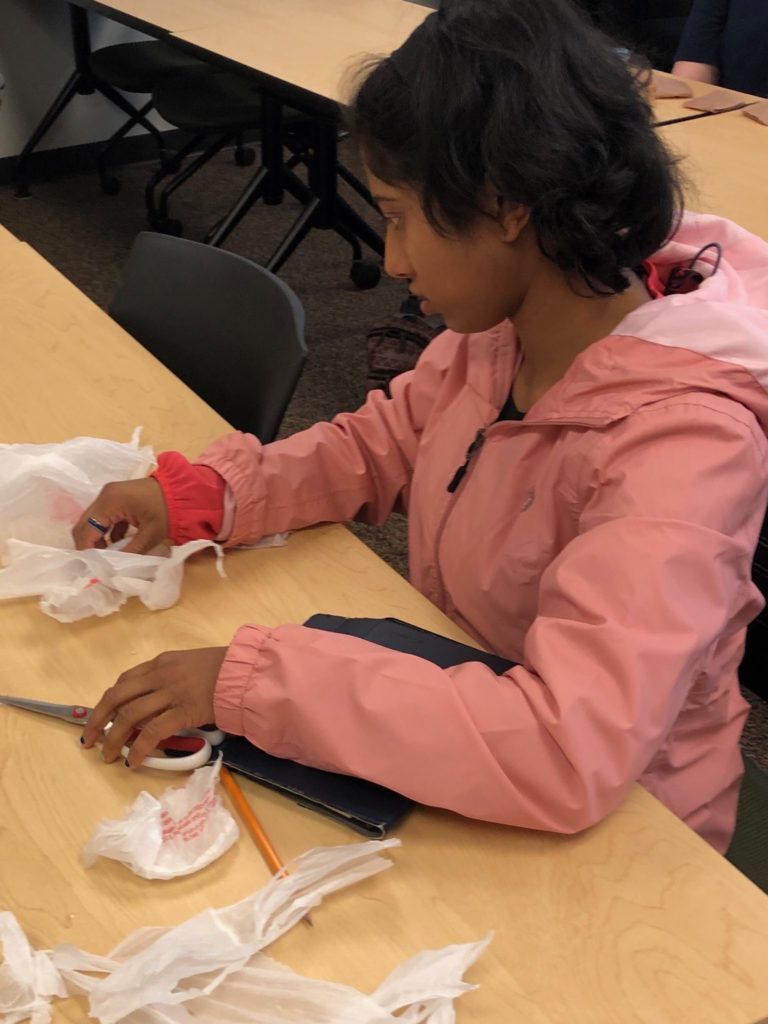 students work on making plarn out of plastic bags