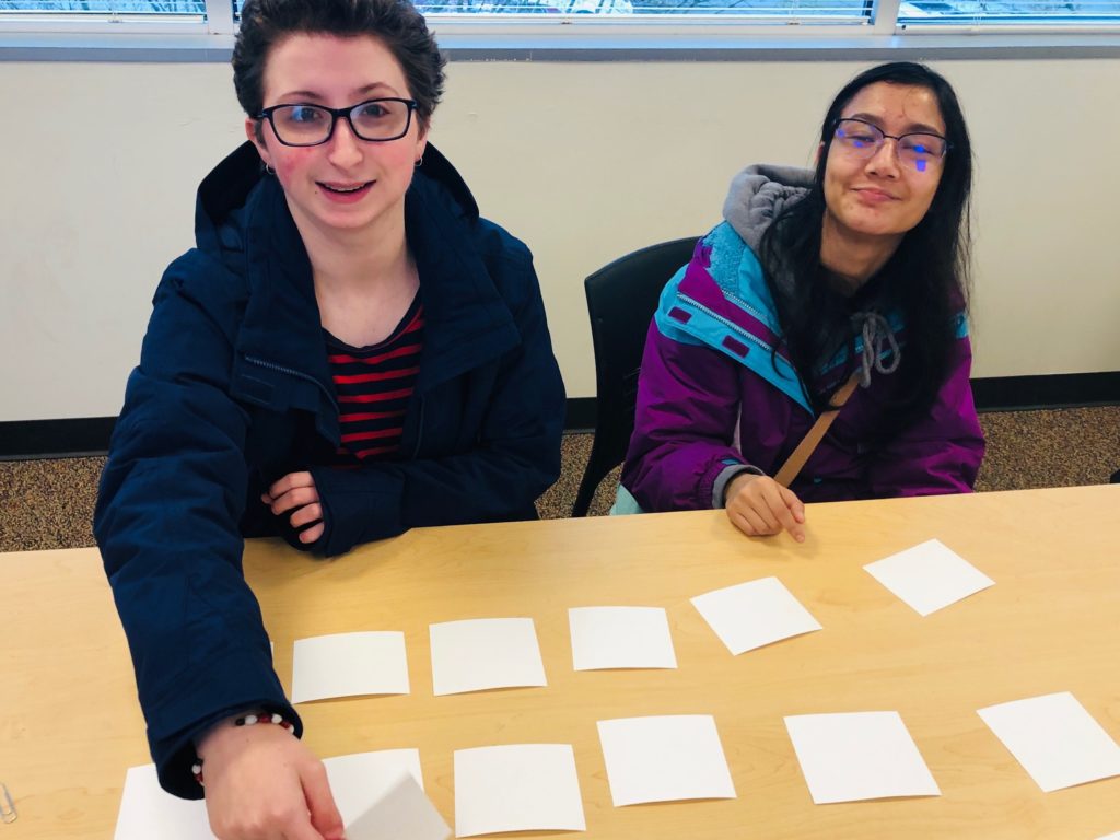 two young adult students play a memory game