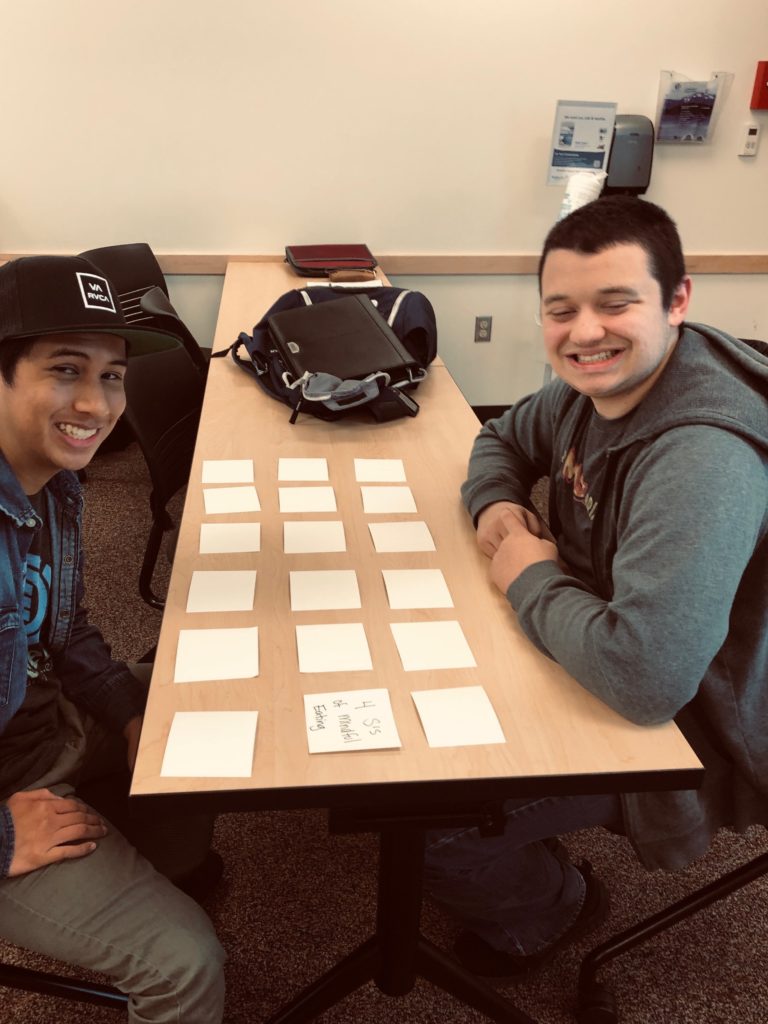 two young adult students play a memory game