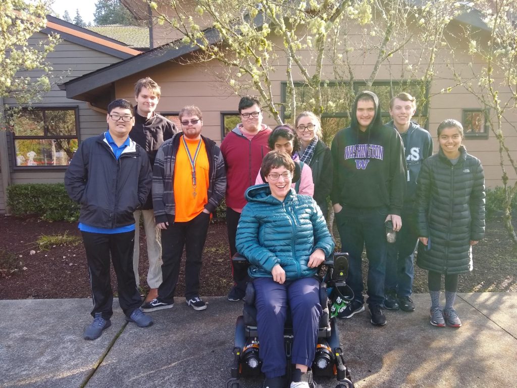 group of smiling young adult students outside 