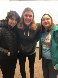 three young adults smile for the camera