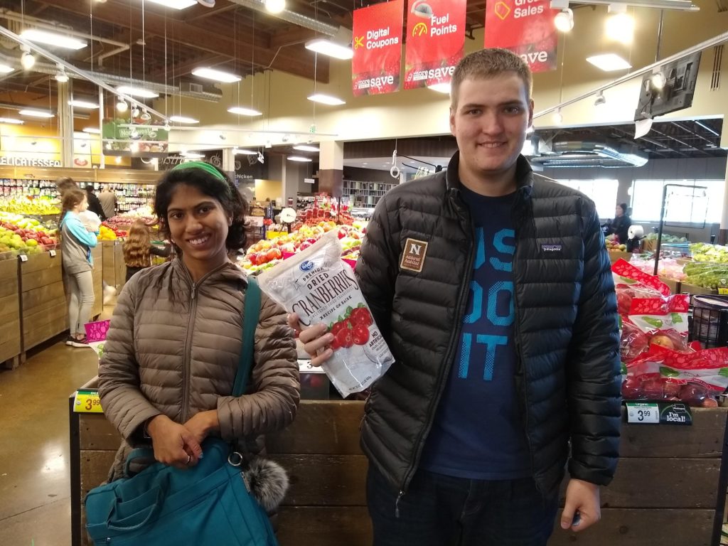 two young adults shop in a grocery store