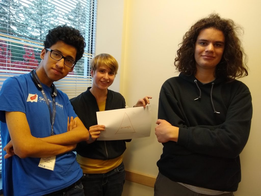 three students in college classroom