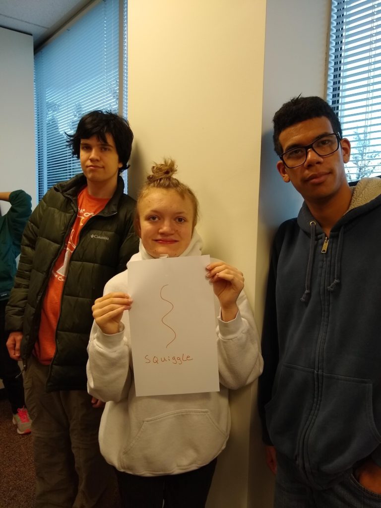 three students in college classroom