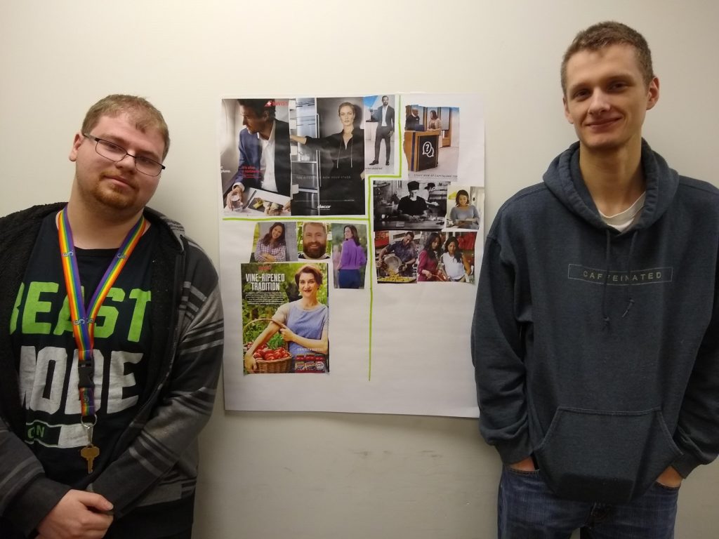 two young adult men pose for a photo with a collage of magazine images