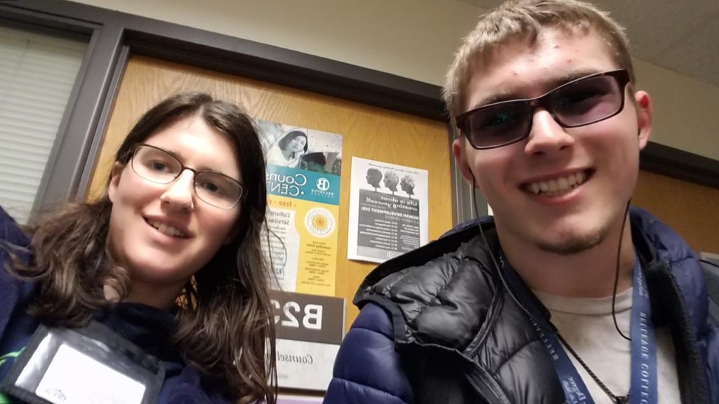 selfie photo of young man and young woman in glasses