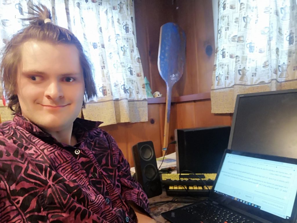 young adult male sitting working at a computer