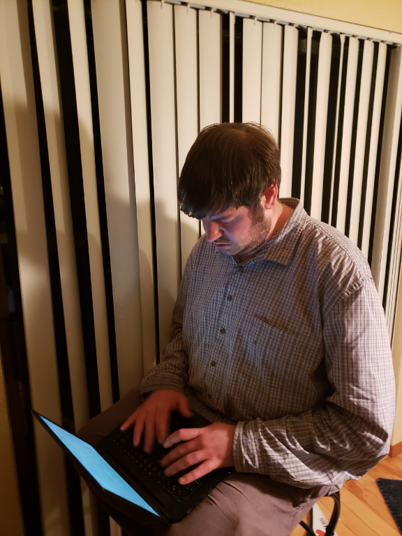 picture of a young man working on a laptop