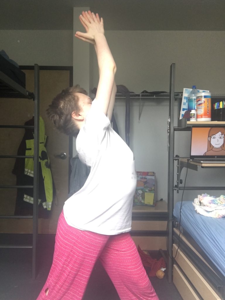 a young woman does yoga in her bedroom