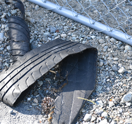 piece of torn tire on gravel path