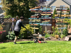 young man mows backyard