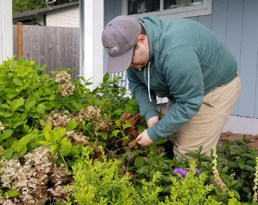 young man works in a garden