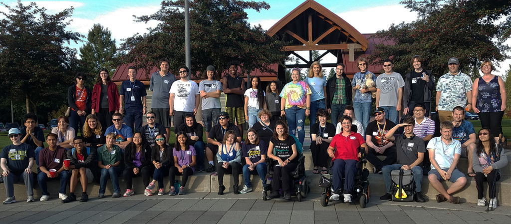 Group picture of large group of OLS students at a park for the 2019 student orientation. 