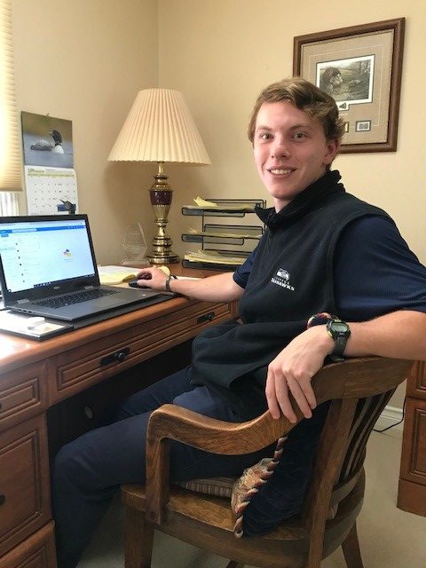 An OLS student works on his home computer