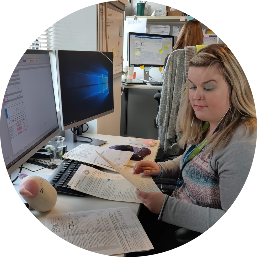 OLS Student sits at an office desk for their internship