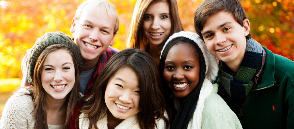 group of teenage friends in a park in autumn