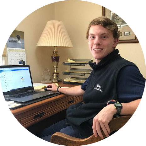 OLS Student sits at a desk in their home, learning online