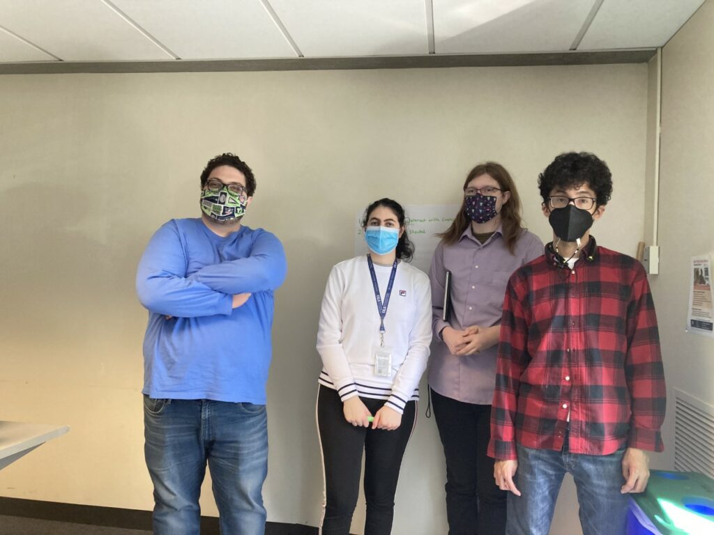 Four OLS students inside wearing masks