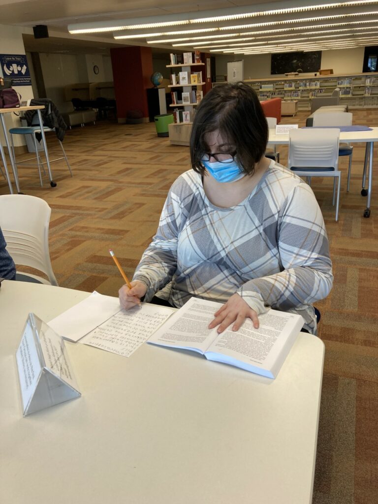 AN OLS Students works on their zine the Bellevue College library. 