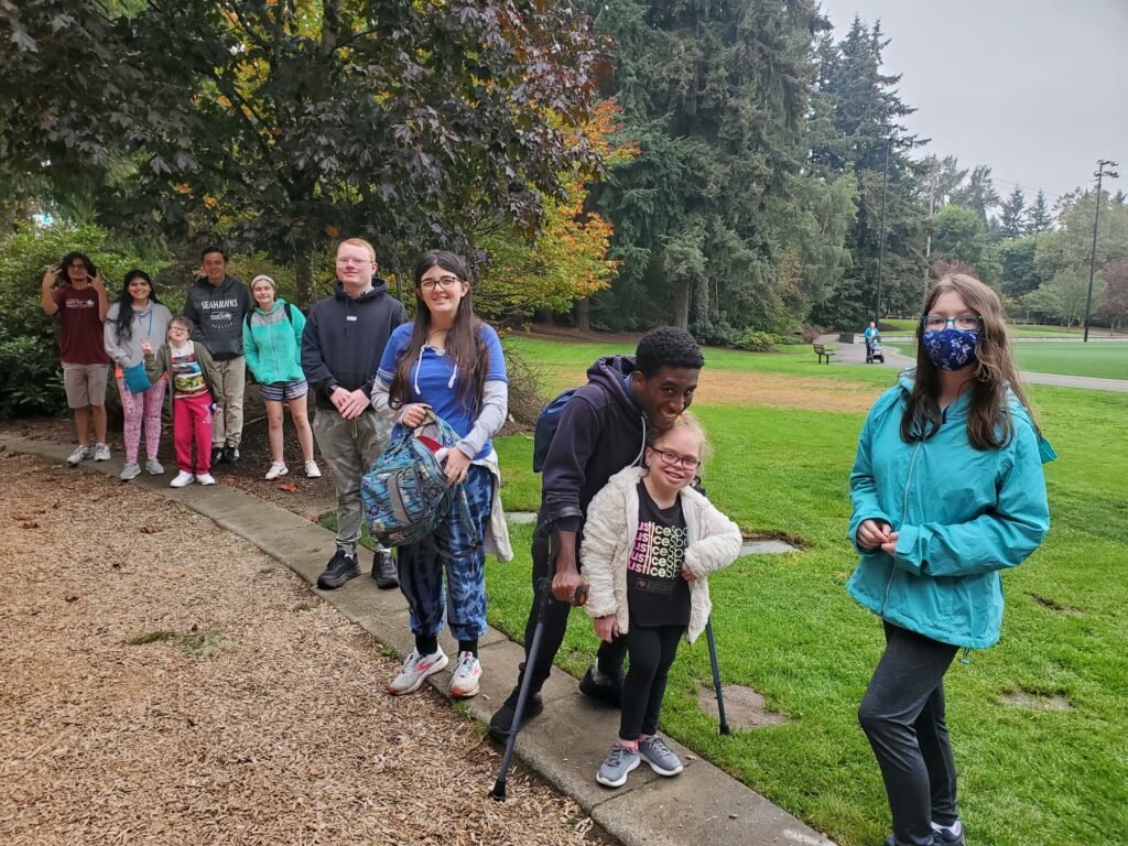 a group of OLS students pose for a photo outside at a park