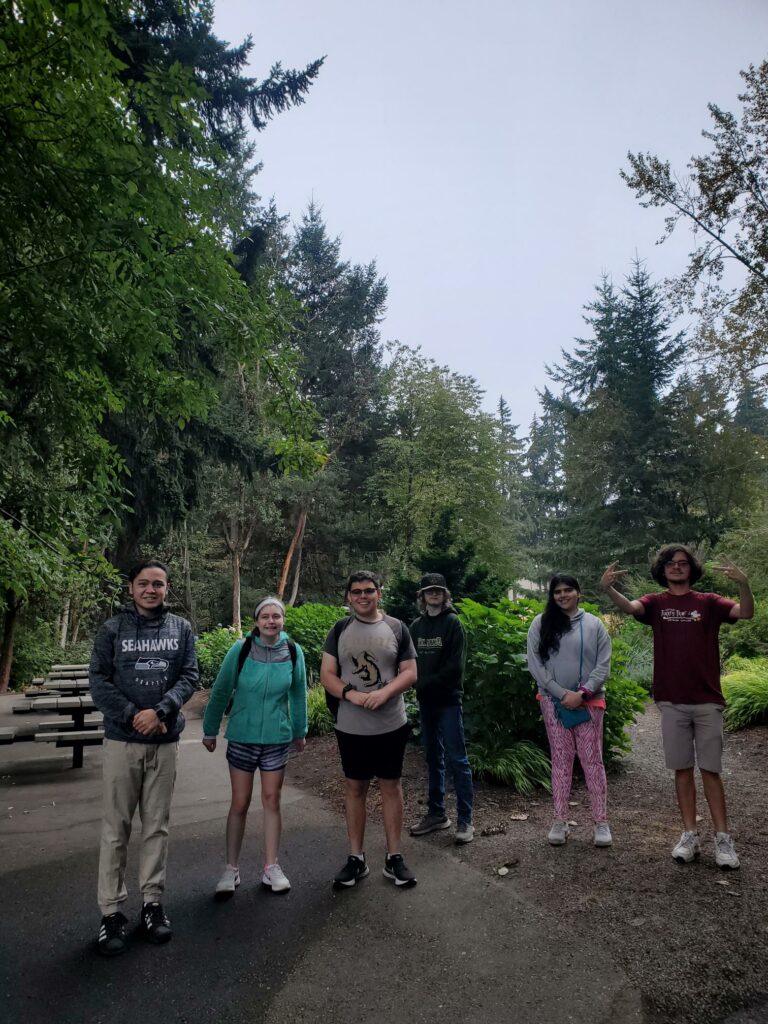 a group of OLS students pose for a photo outside at a park