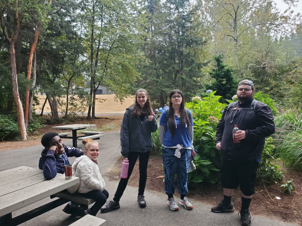 a group of OLS students pose for a photo at a park