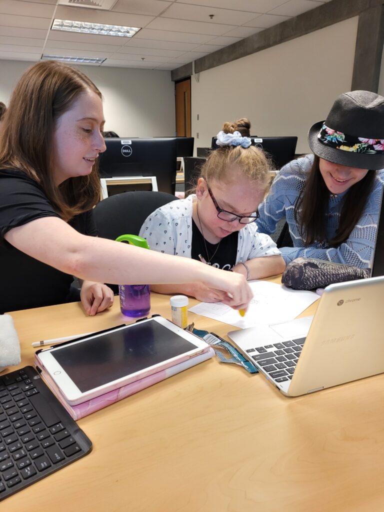 three OLS students working as a group in class