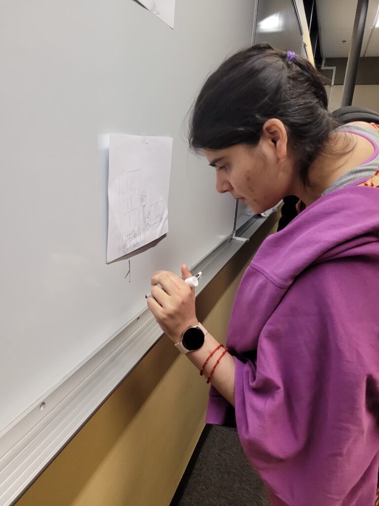 An OLS student works at the whiteboard in class