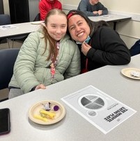 Two OLS students smiling in class