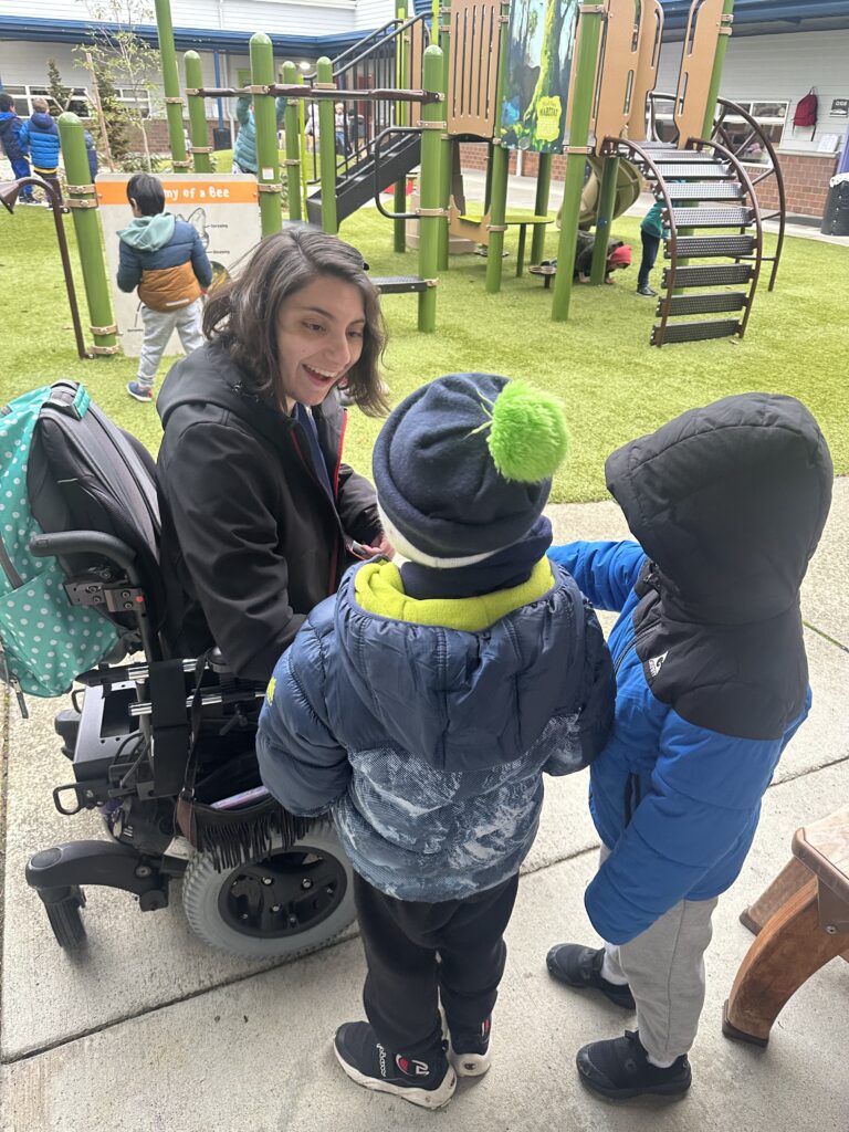 An OLS student talking to children on a playground