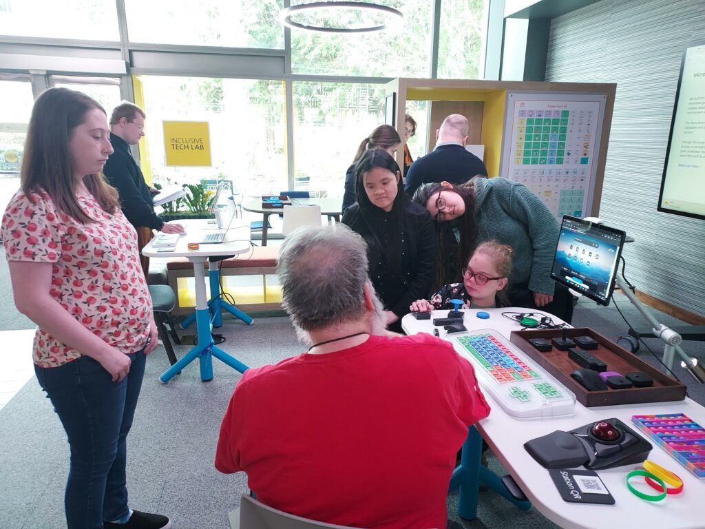 a group of OLS students explore various technologies in an office space